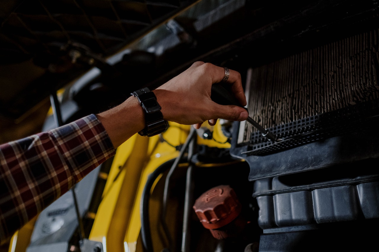 Person Fixing the Engine Air Filter of a Truck | Veteran Car Donations