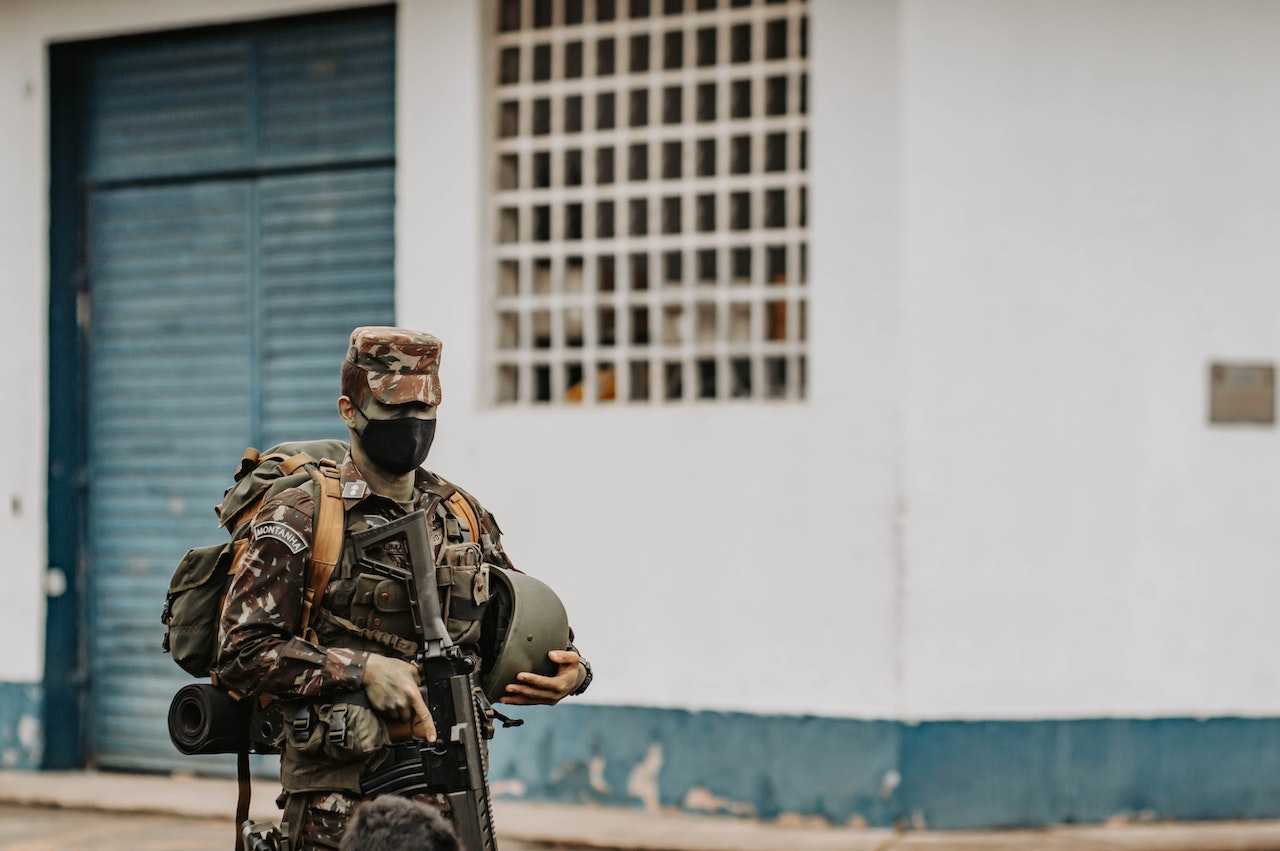 Soldier with Weapon on City Street | Veteran Car Donations