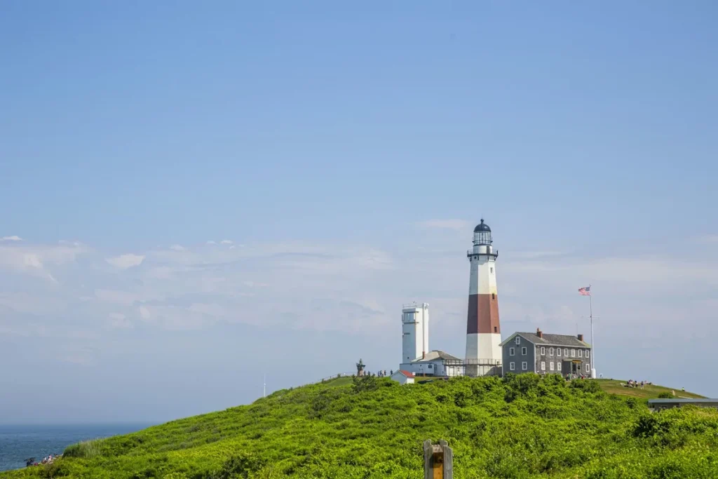 A lighthouse on top of a grassy hill in East Hampton
