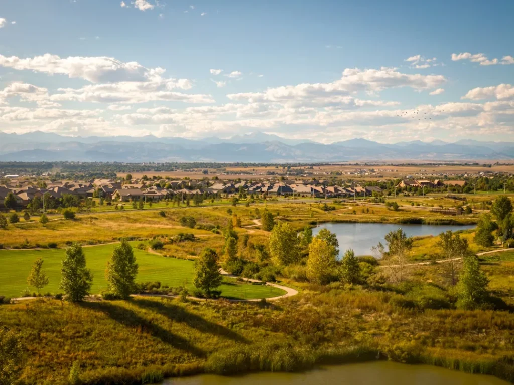A Scenic View of a Golf Course with a Lake in the Foreground in Broomfield, Colorado