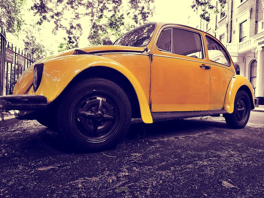 Closeup photo of yellow Volkswagen Beetle coupe