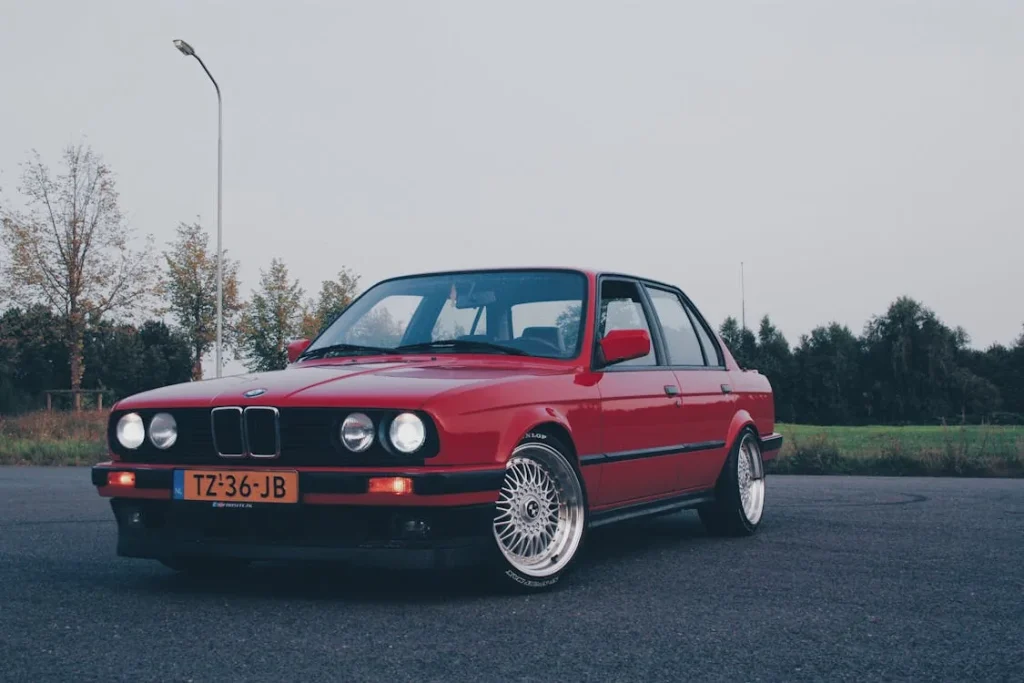 Photography of Red BMW on Asphalt Road