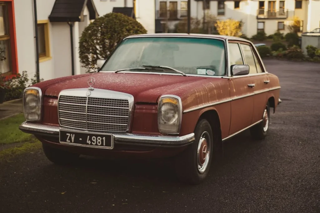 Red Mercedes-Benz W114 Sedan Parking Near House