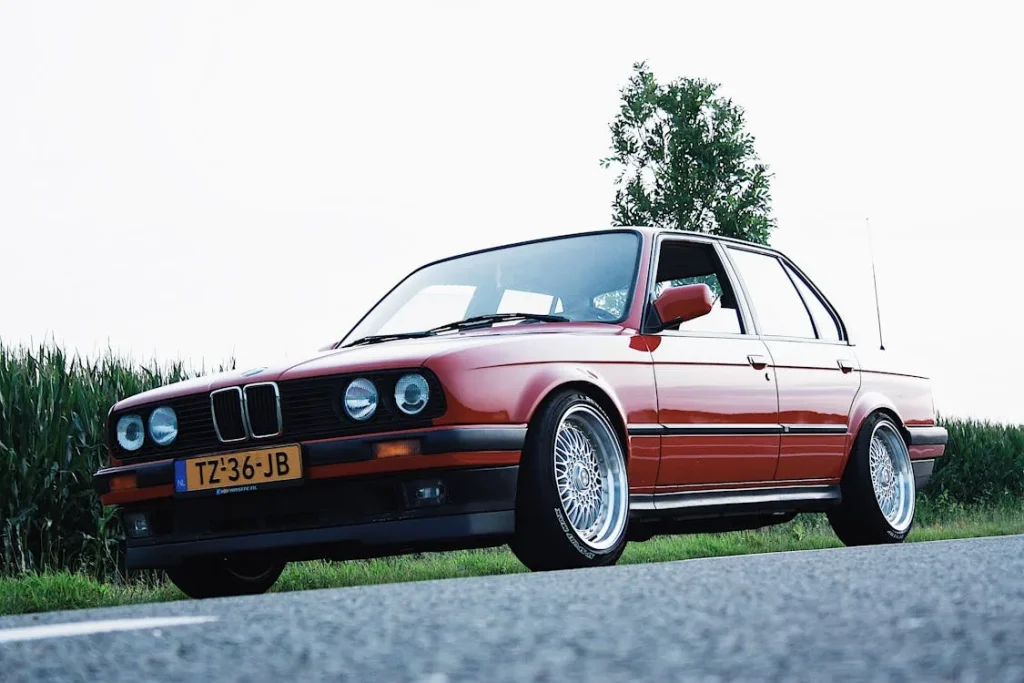 Red Sedan on Grey Concrete Road