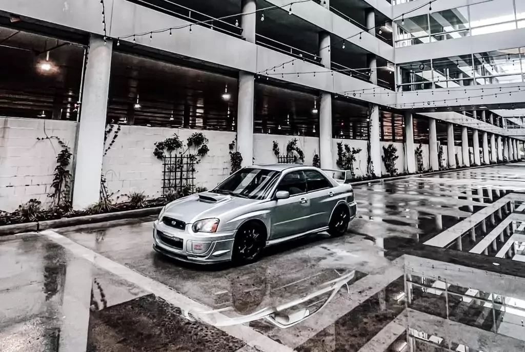 Silver sedan parked on gray concrete road
