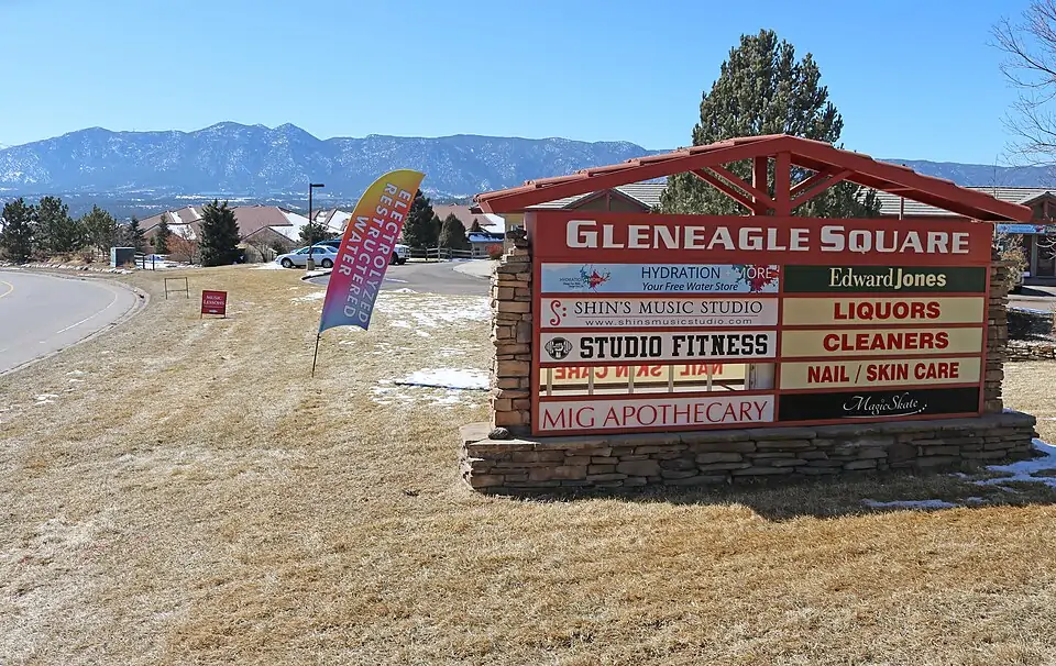 View of Gleneagle Square shopping center with the Rampart Range in the distance in Gleneagle, Colorado
