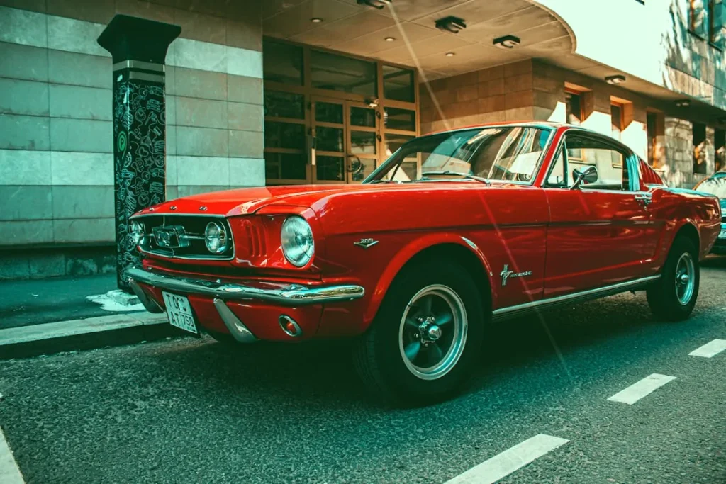 Red Ford Mustang parked on a city street