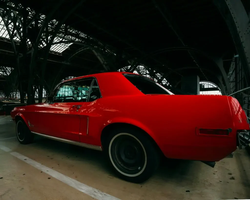 Red vintage car parked inside a garage