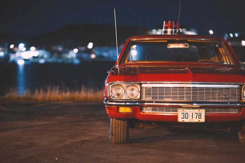 A red vintage car parked on the road
