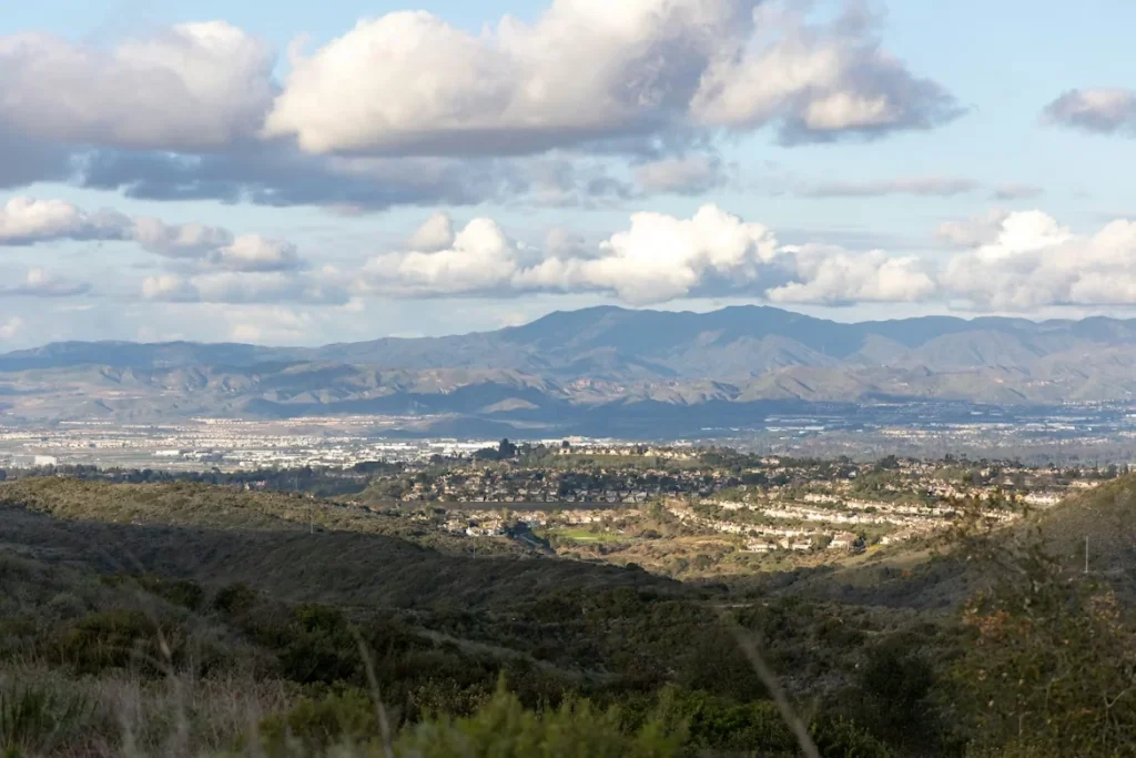 A view of a city and mountains from a hill in Laguna Hills, California