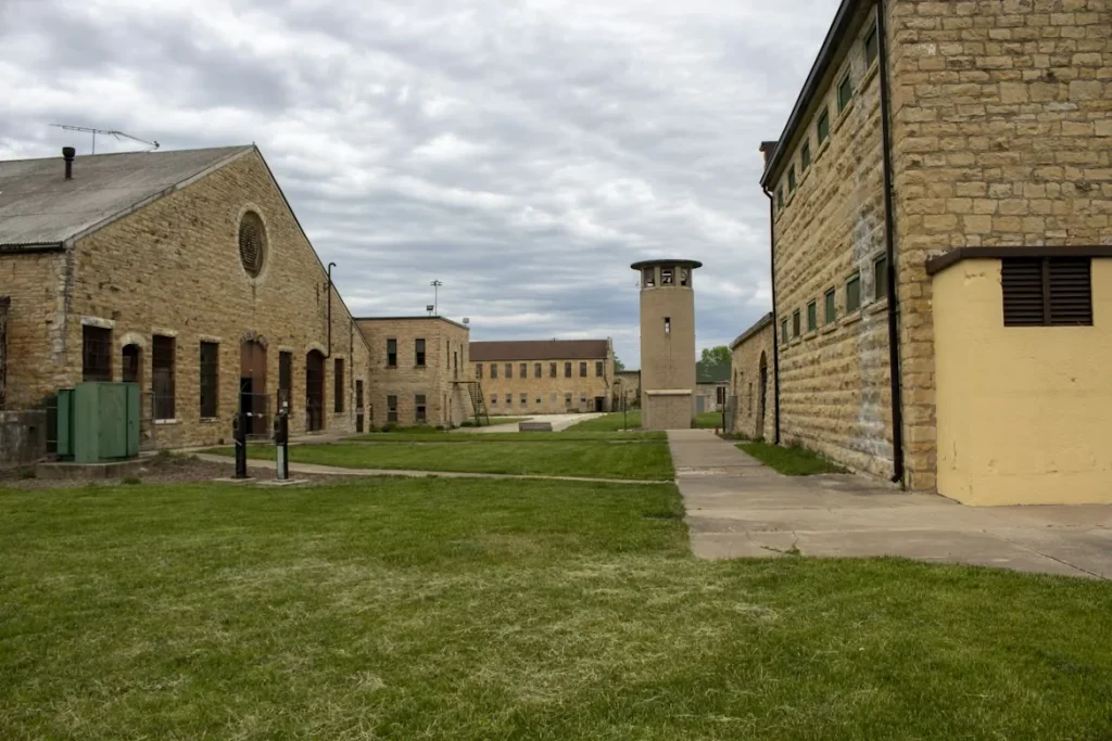 Grassy courtyard between brick buildings at Old Joliet Prison in Joliet, Illinois
