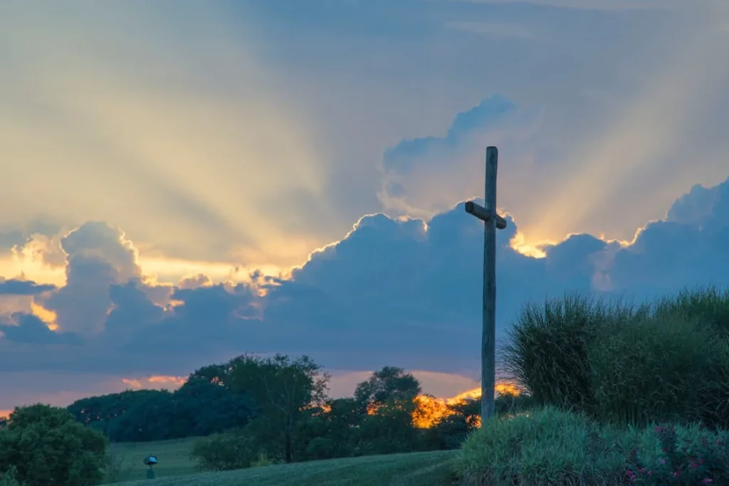 Big wooden cross on green grass field under the white clouds in Frederick, Maryland
