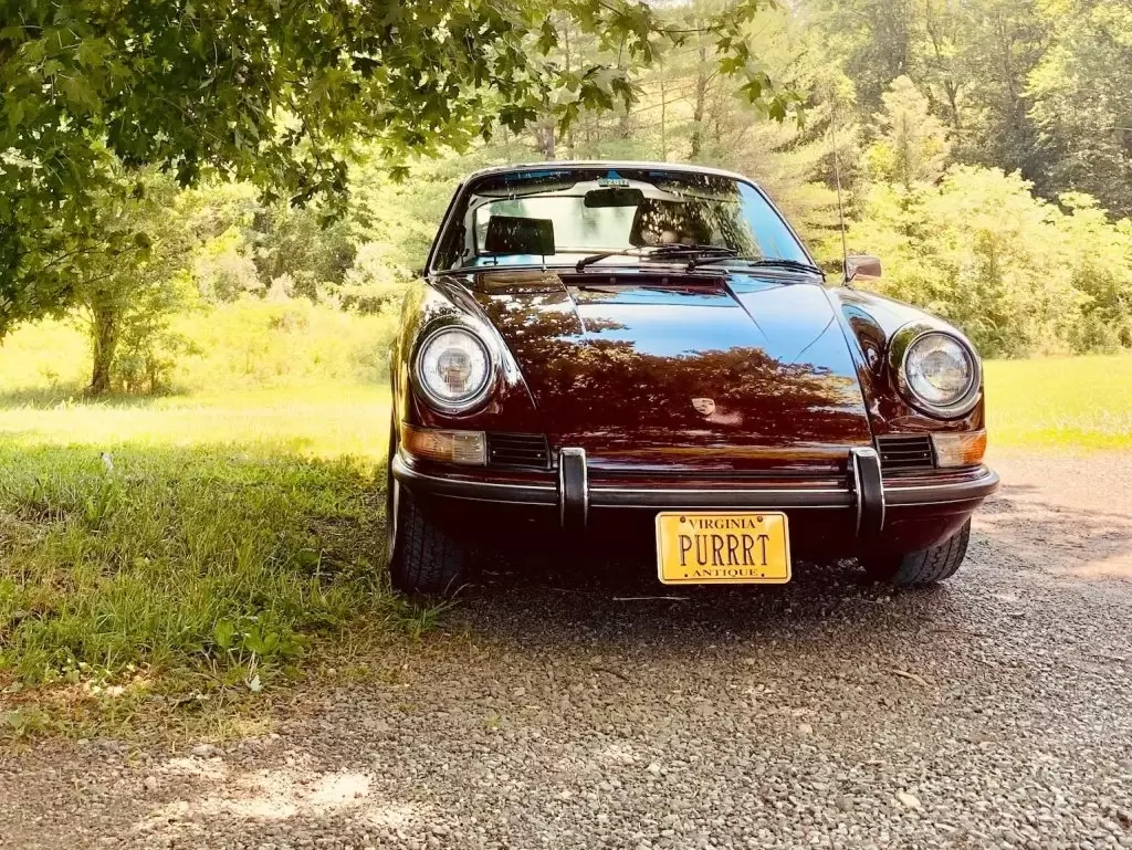 Black Porsche parked on grass