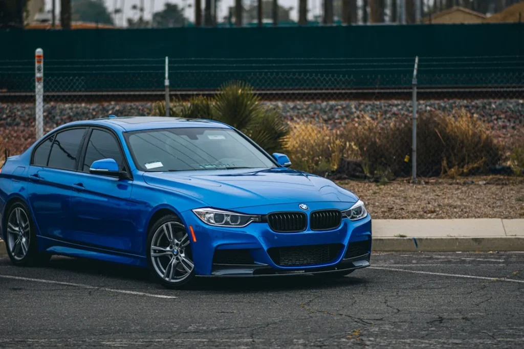 Blue BMW parked on a road