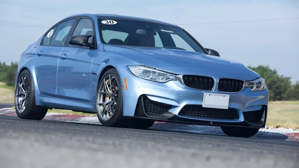Blue sedan parked during daytime