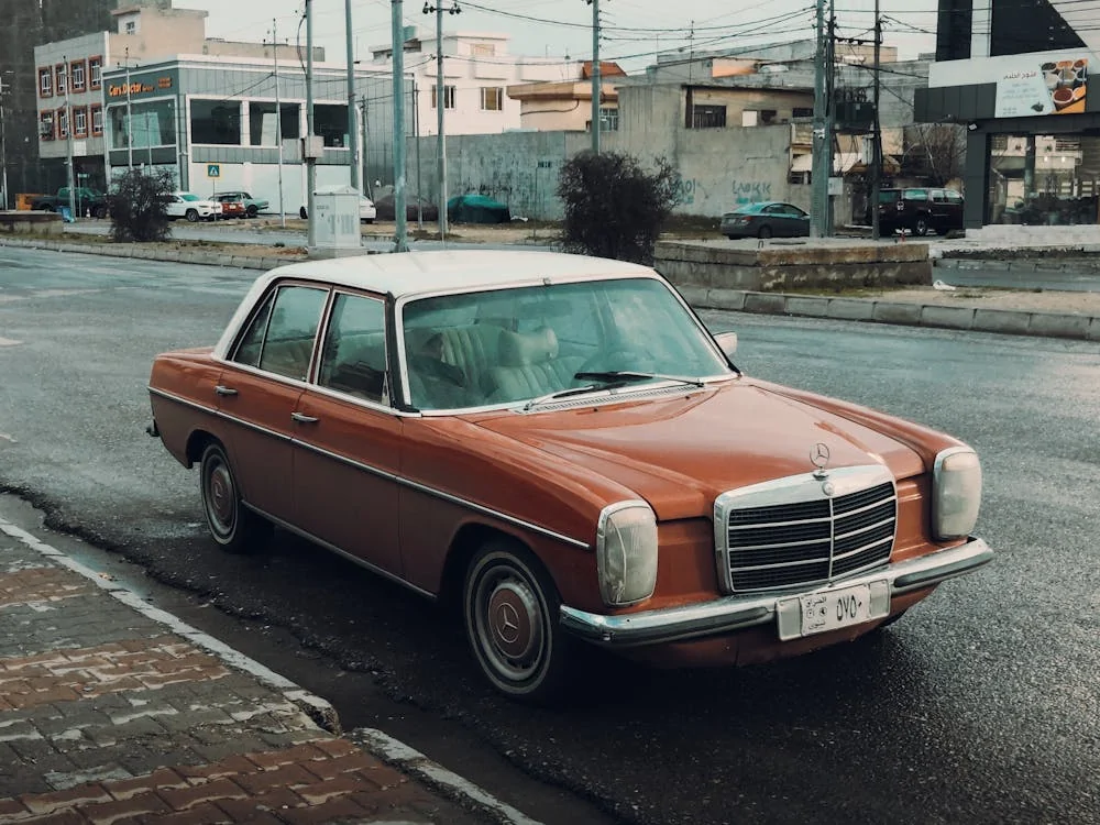 Brown Mercedes vintage car on asphalt road