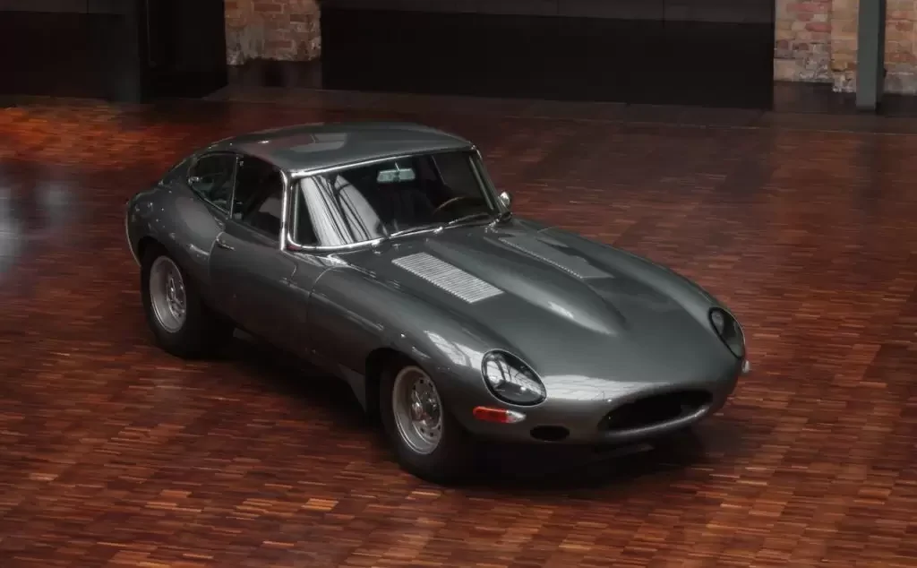 Gray sports car parked on a wooden floor