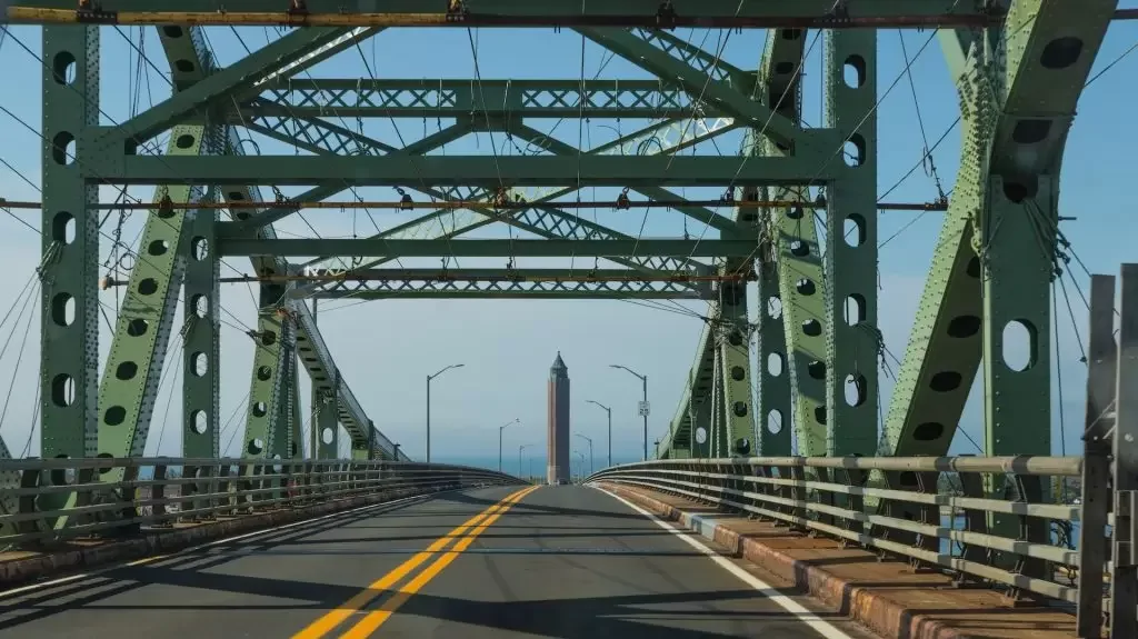 A view of a bridge with a tower in the distance in Islip, New York