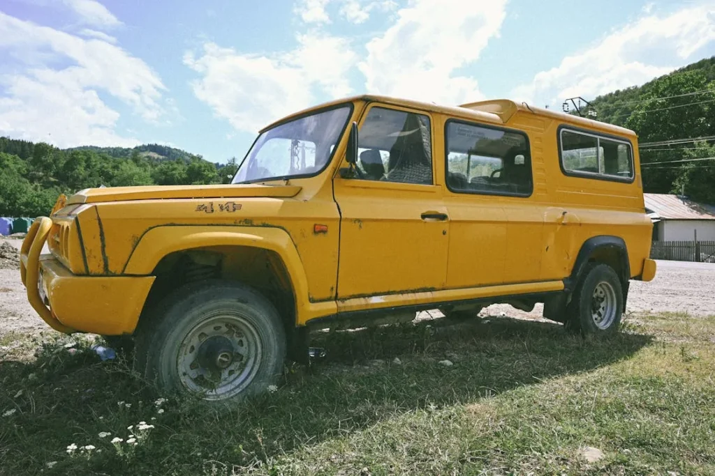 Photo of an old off-road car in a field