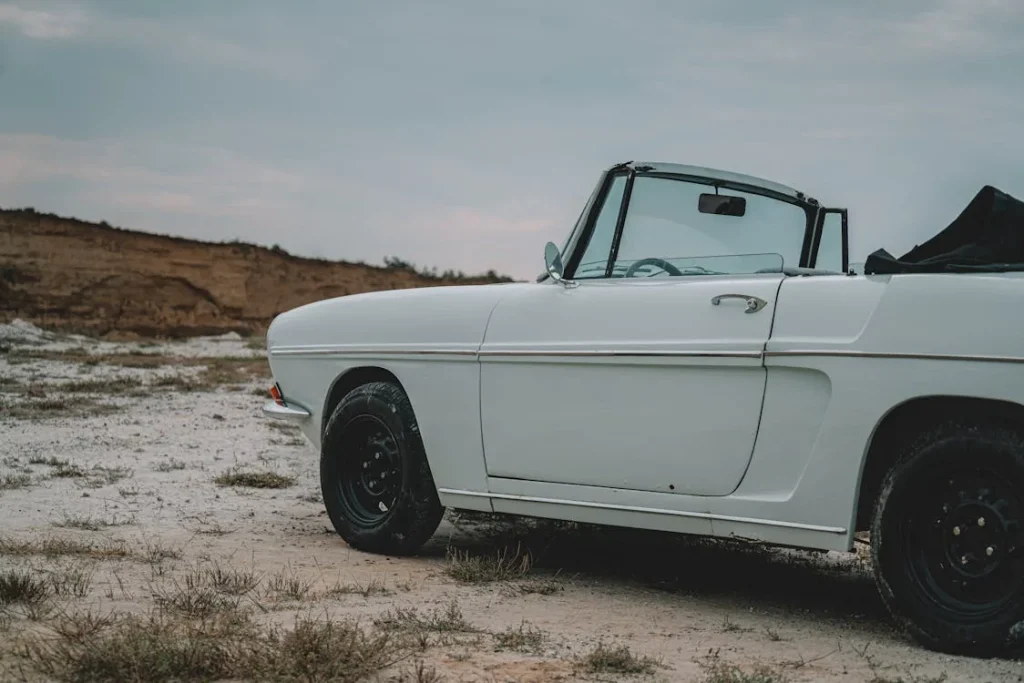 Photo of a white car on a rural dirt road