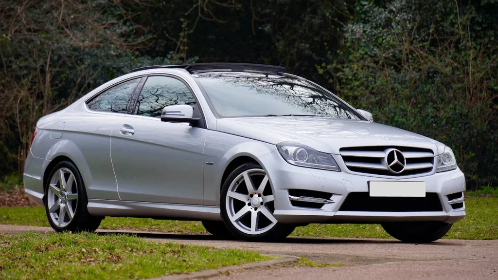 Silver Mercedes-Benz coupe on a scenic road