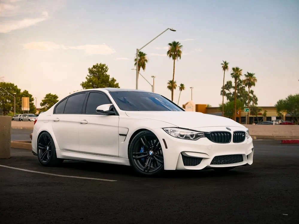 Close-up of a white BMW parked in a parking lot