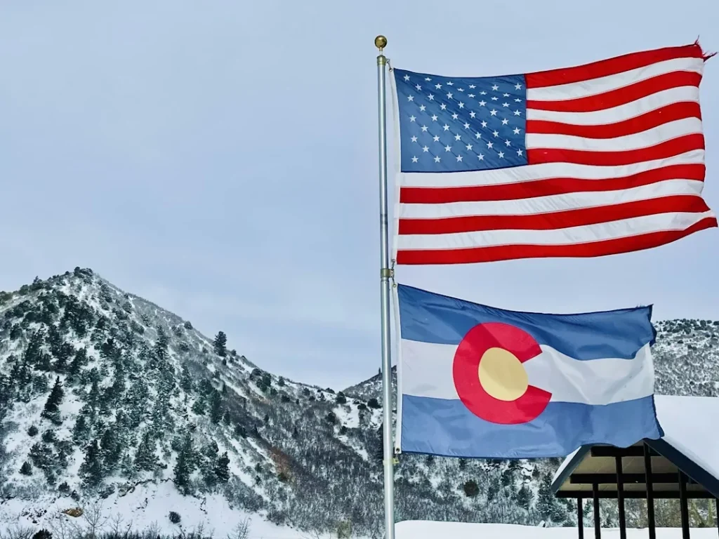 US and Colorado flag on a pole