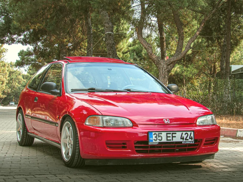 Vibrant red Honda Civic hatchback in scenic setting