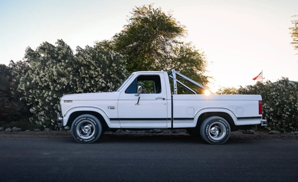 Photo of a vintage white pickup truck at sunset