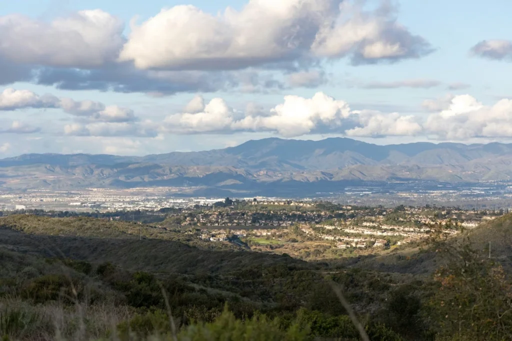 A view of a city and mountains from a hill in Laguna Hills, California